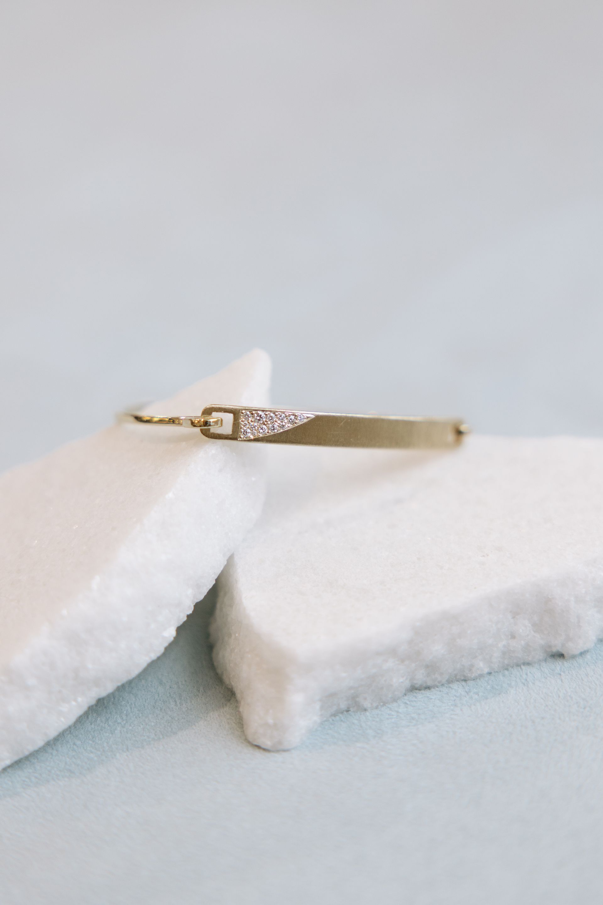 A close up of a bracelet sitting on top of a piece of marble.