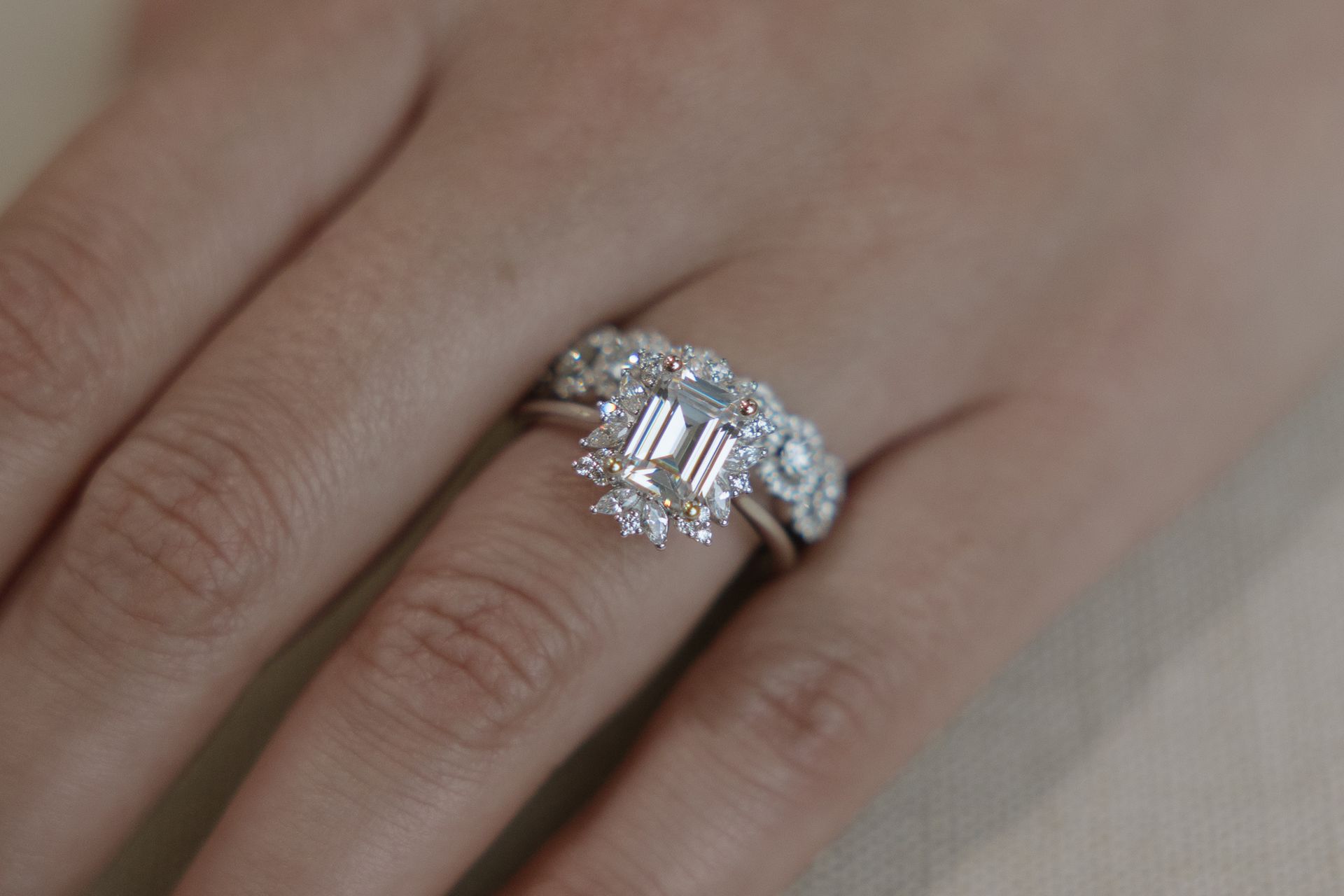 A close up of a woman 's hand with a ring on it