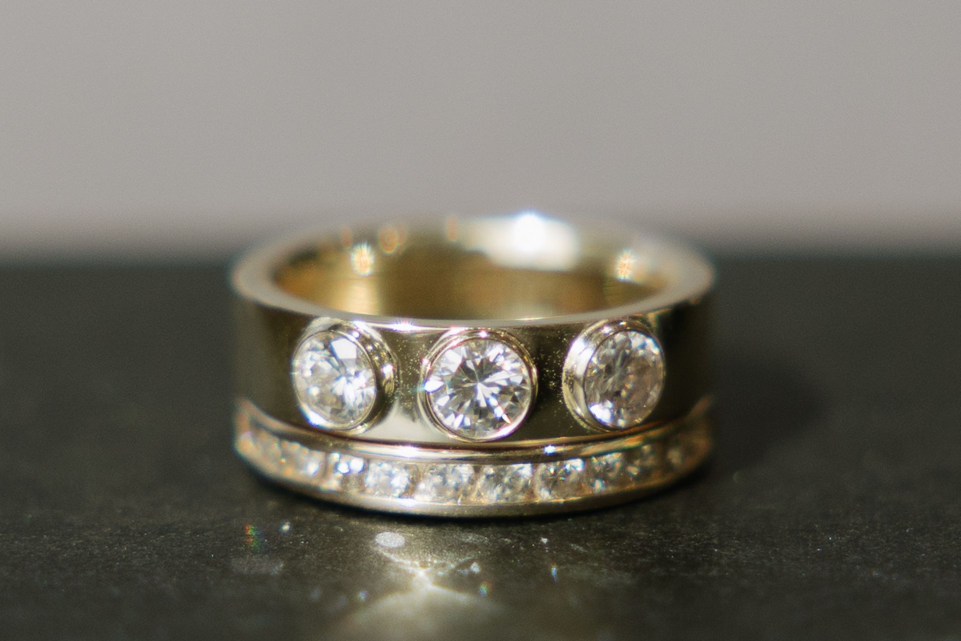 A gold ring with three diamonds on it