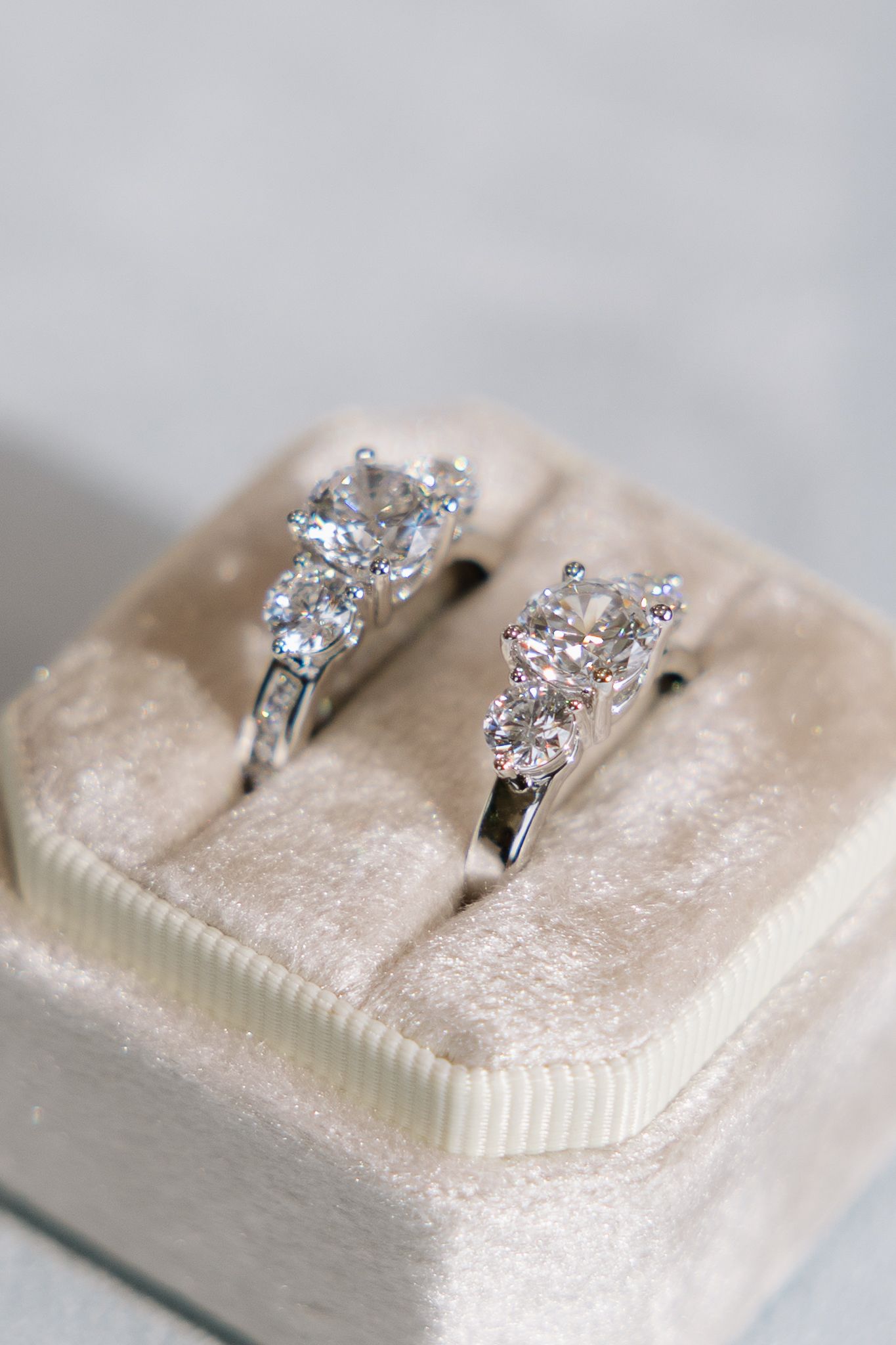 Two wedding rings are sitting in a velvet box.