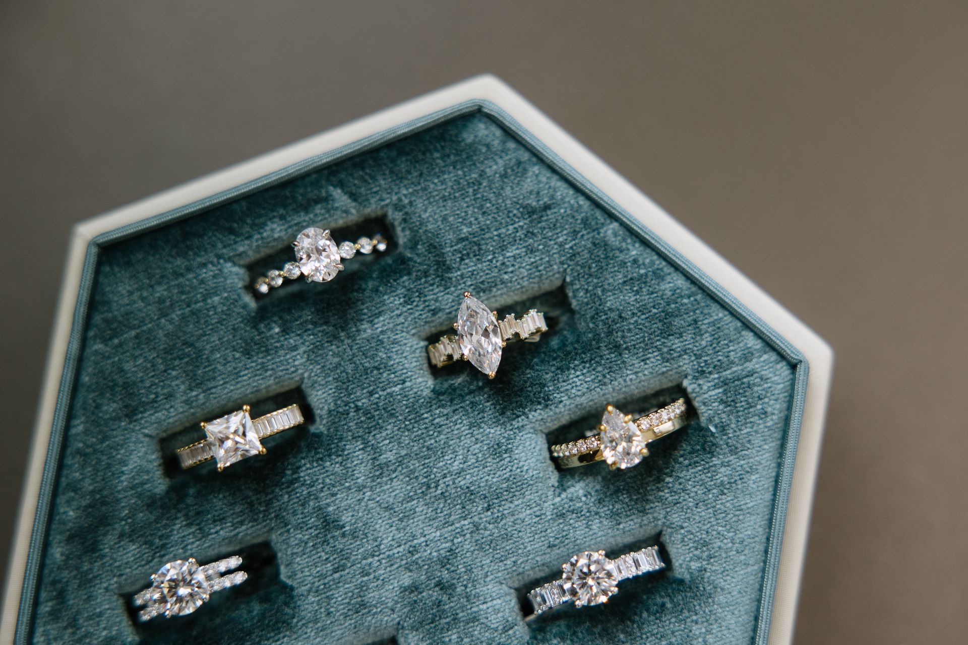 A box filled with lots of rings on a table.