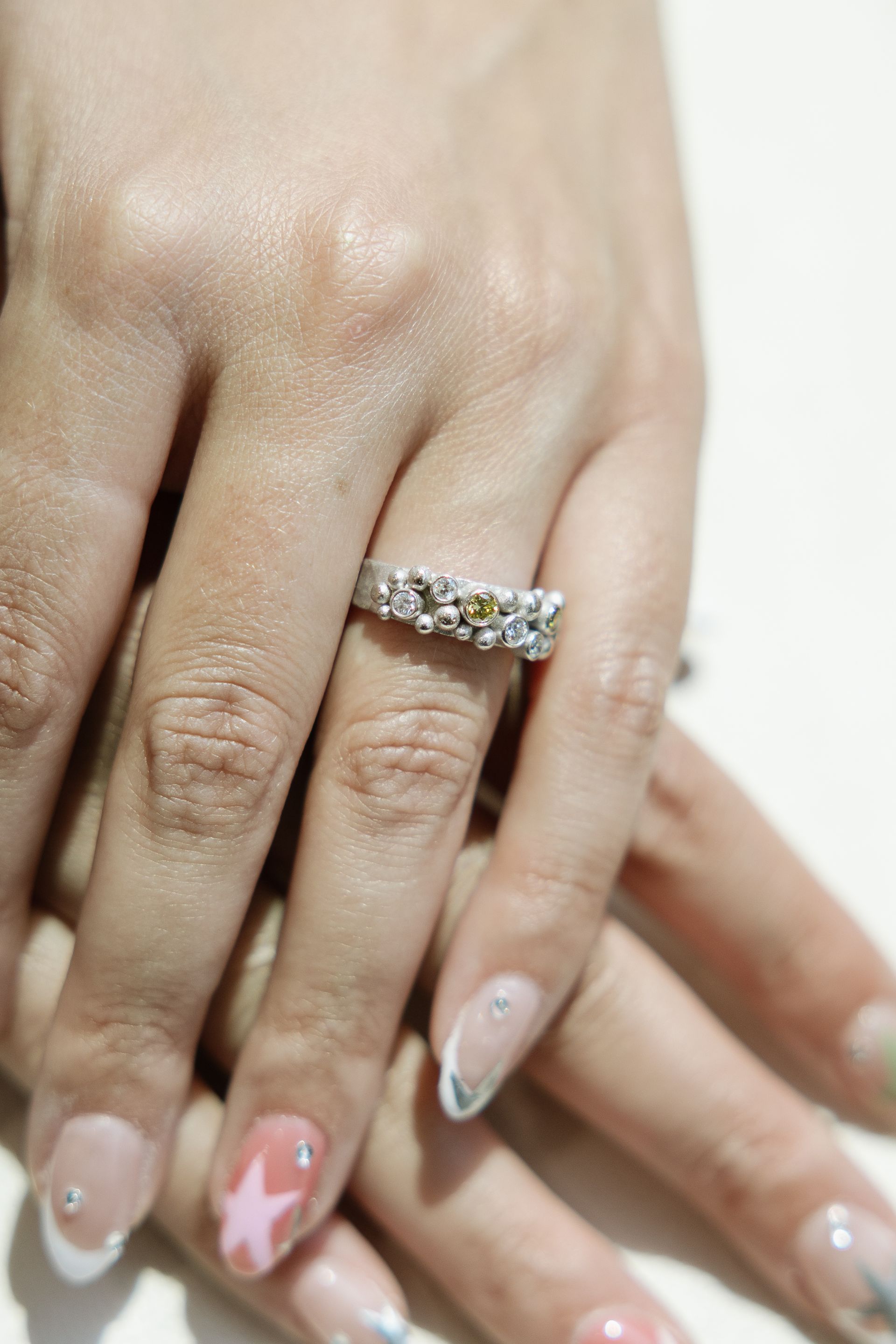 A close up of a woman's hand with a ring on her finger