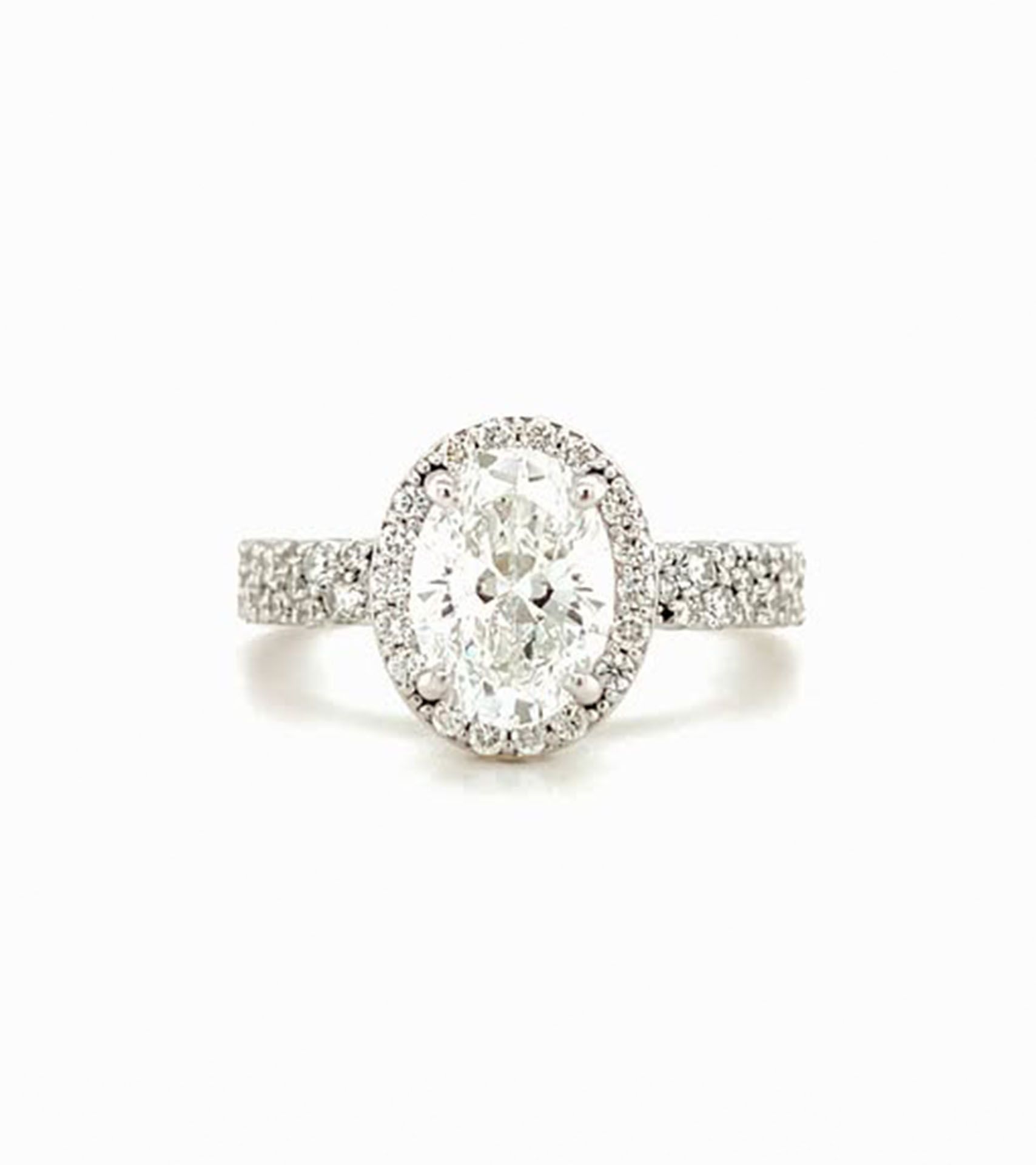 Oval diamond ring with a halo of smaller diamonds and diamond band