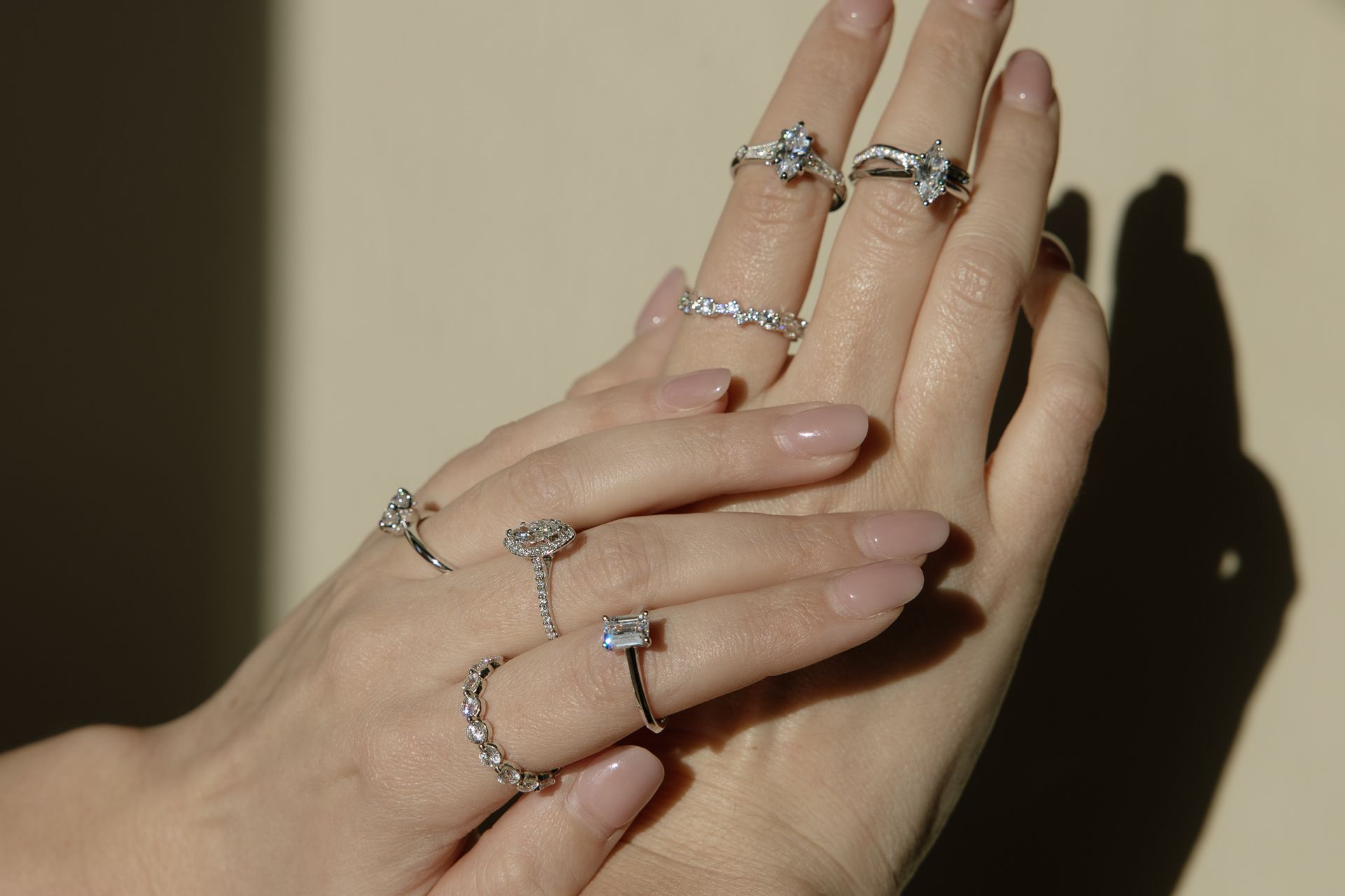 Hands displaying multiple diamond rings.