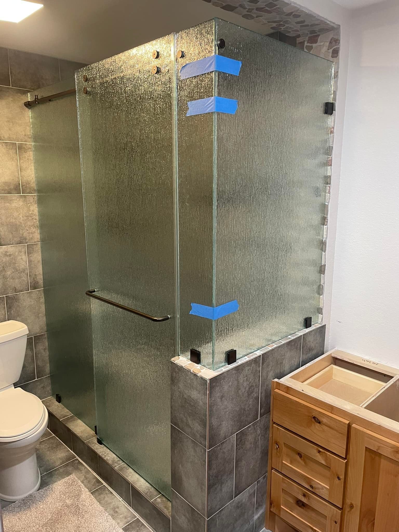 A bathroom with a toilet , sink , and shower stall.