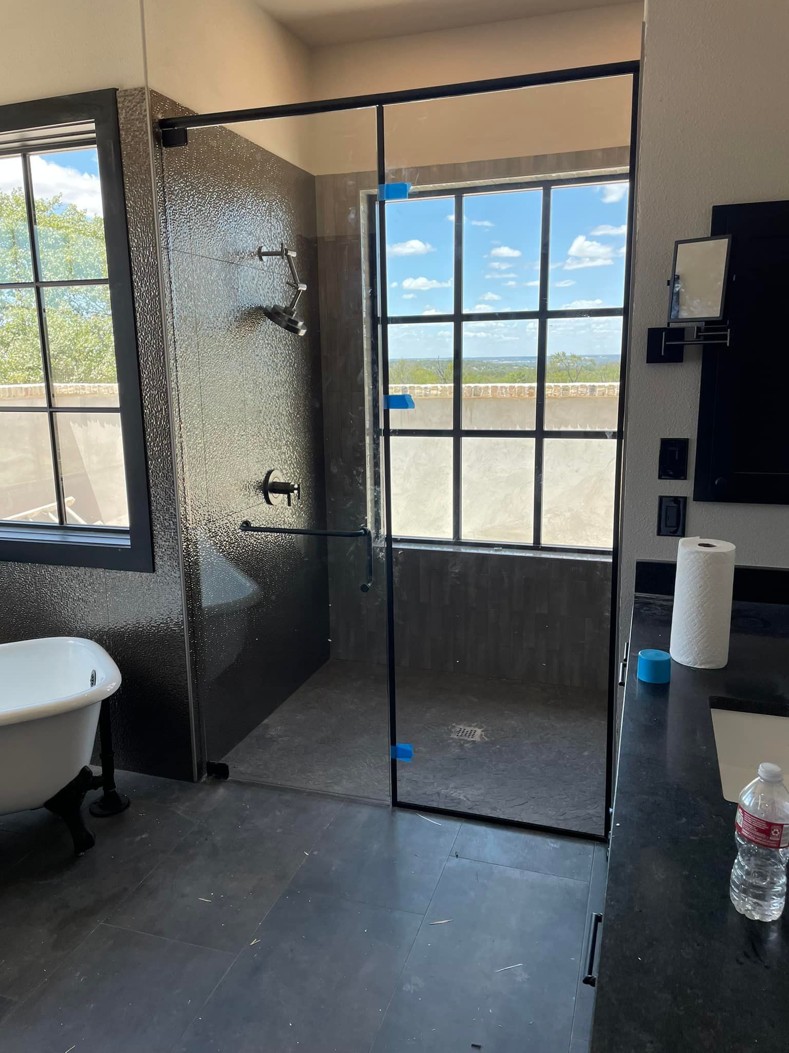 A bathroom with a walk in shower and a bathtub
