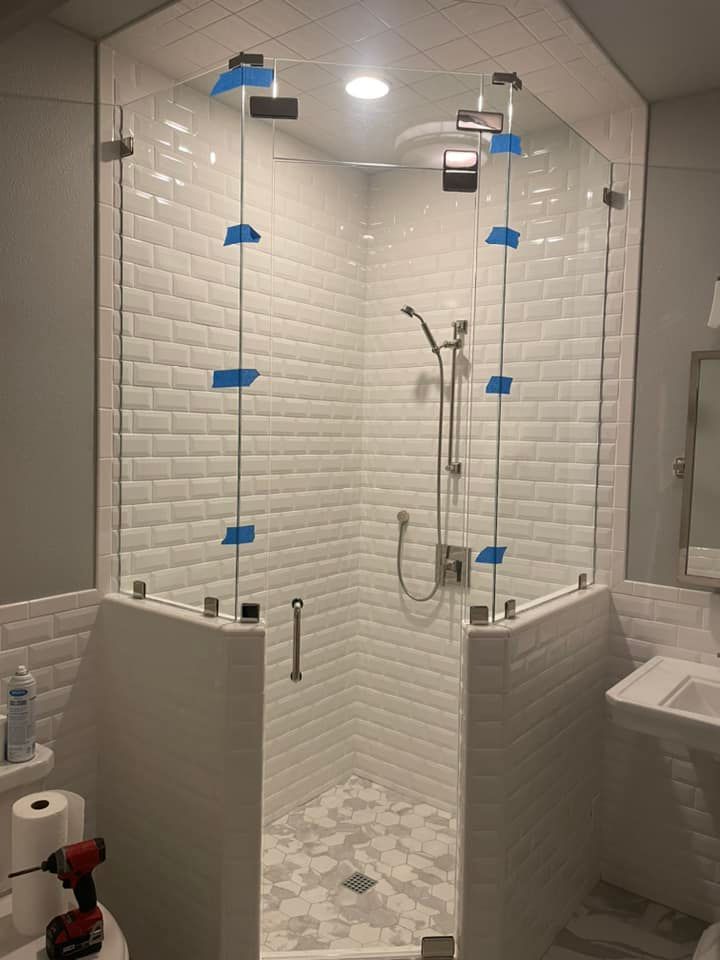 A bathroom with a shower stall and a toilet.