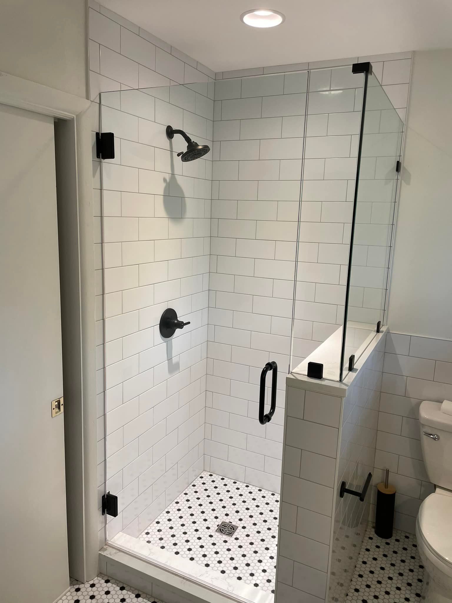 A bathroom with a walk in shower and a toilet.