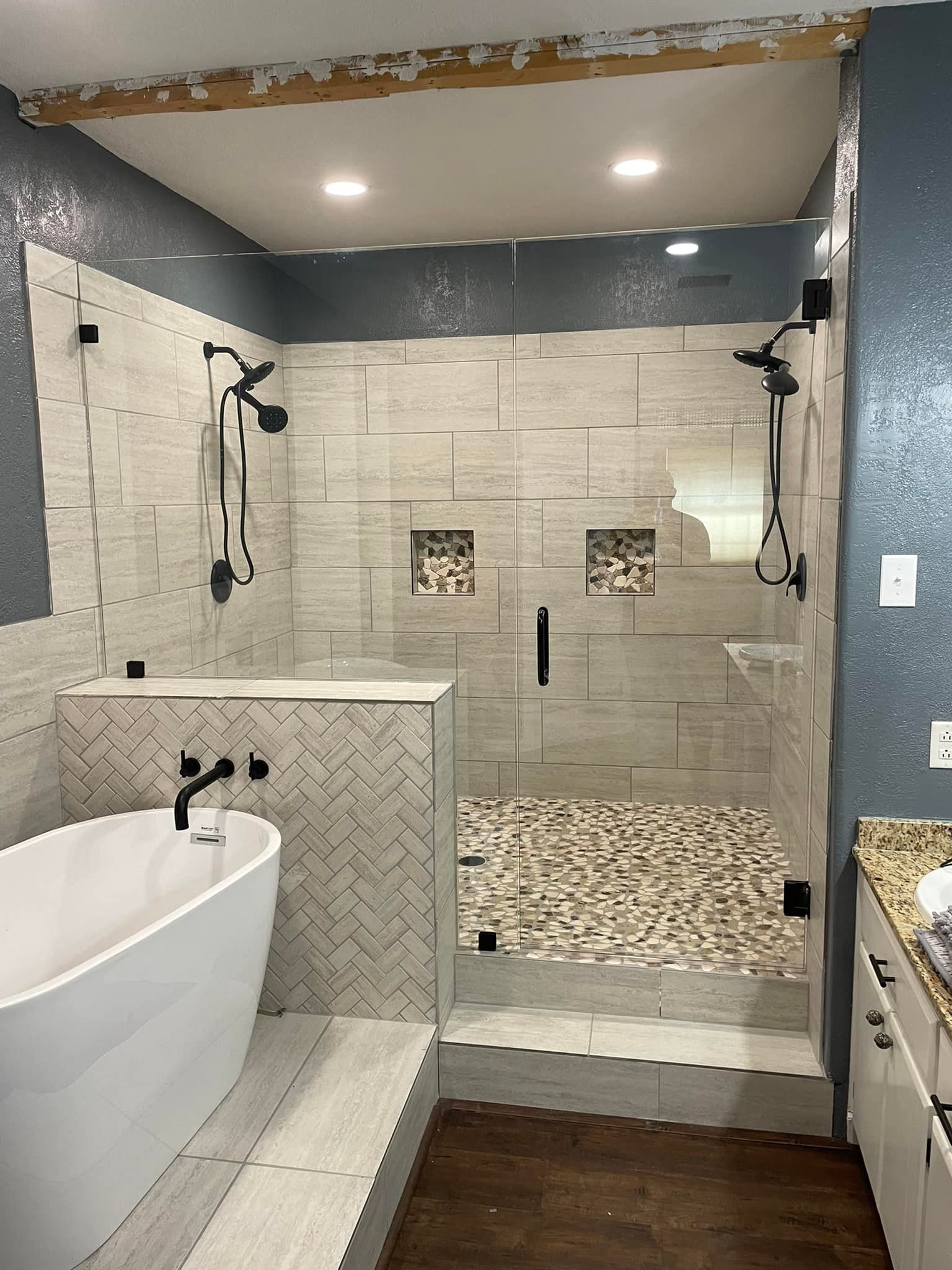 A bathroom with a bathtub and a walk in shower.