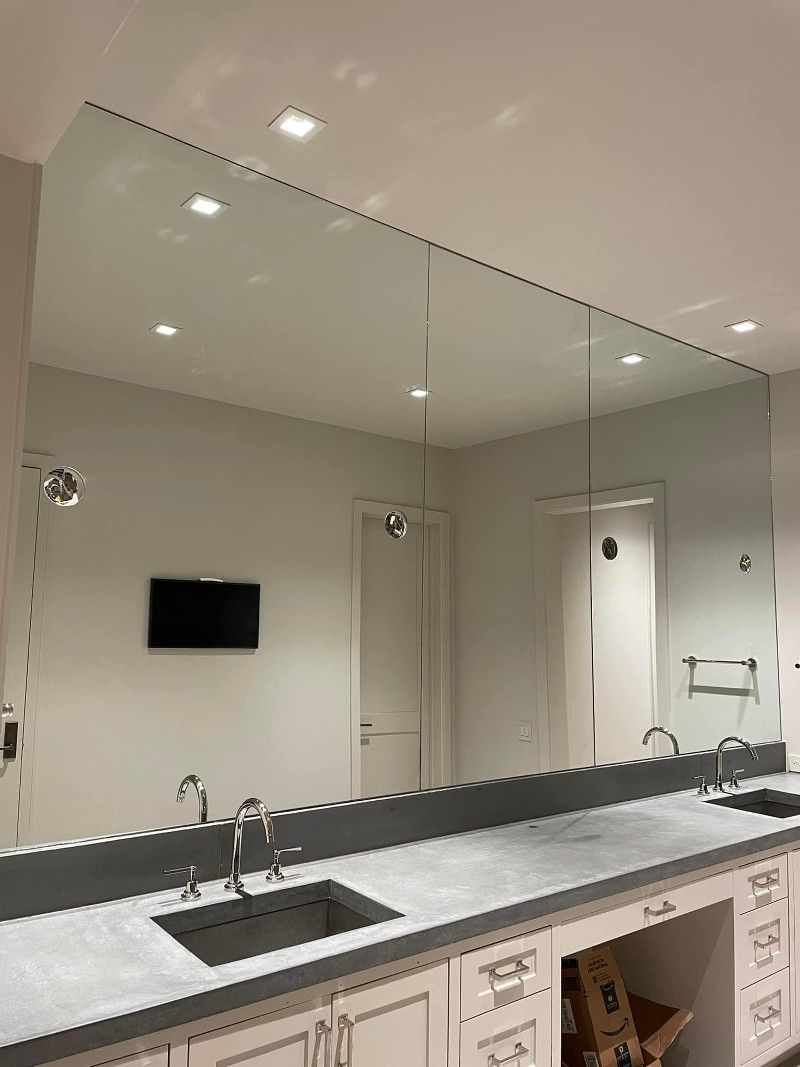 A bathroom with two sinks and a large mirror.