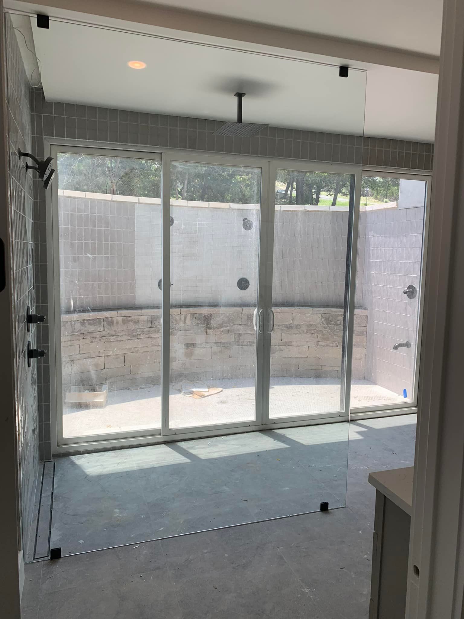 A room with a lot of windows and a sliding glass door