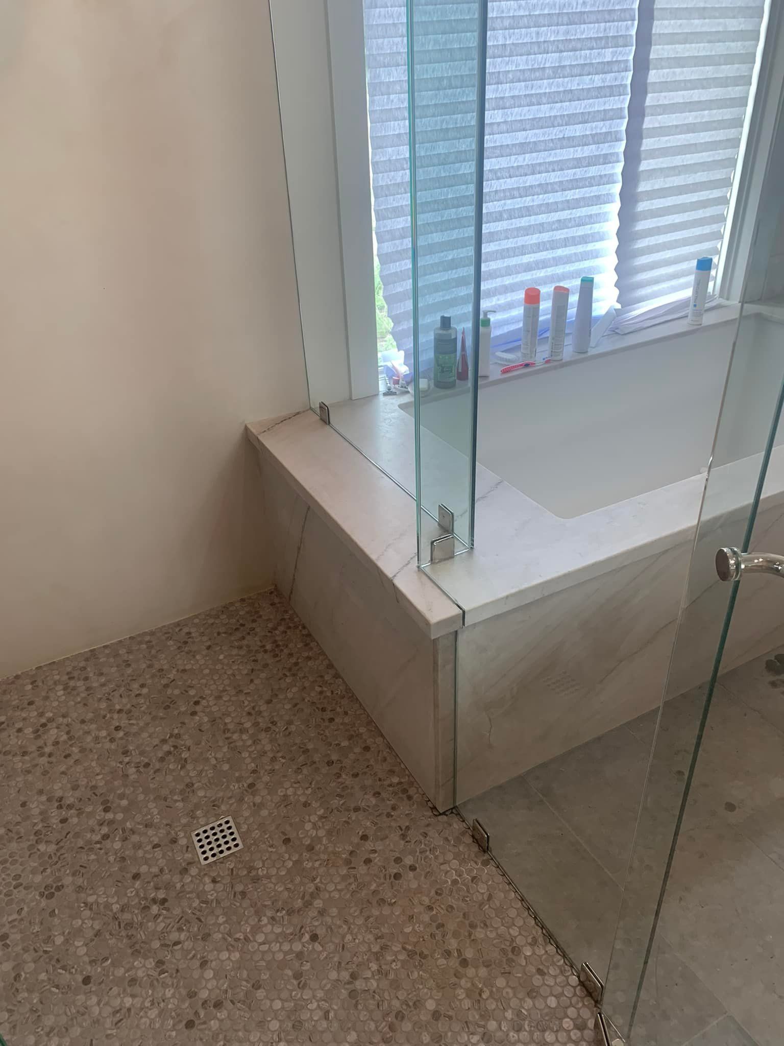 A bathroom with a walk in shower and a bathtub.