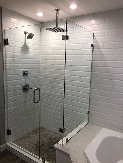 A bathroom with a walk in shower and a bathtub.