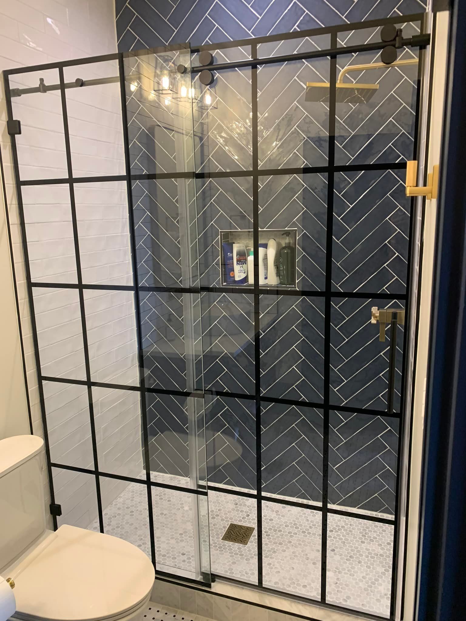 A bathroom with a walk in shower and a toilet.