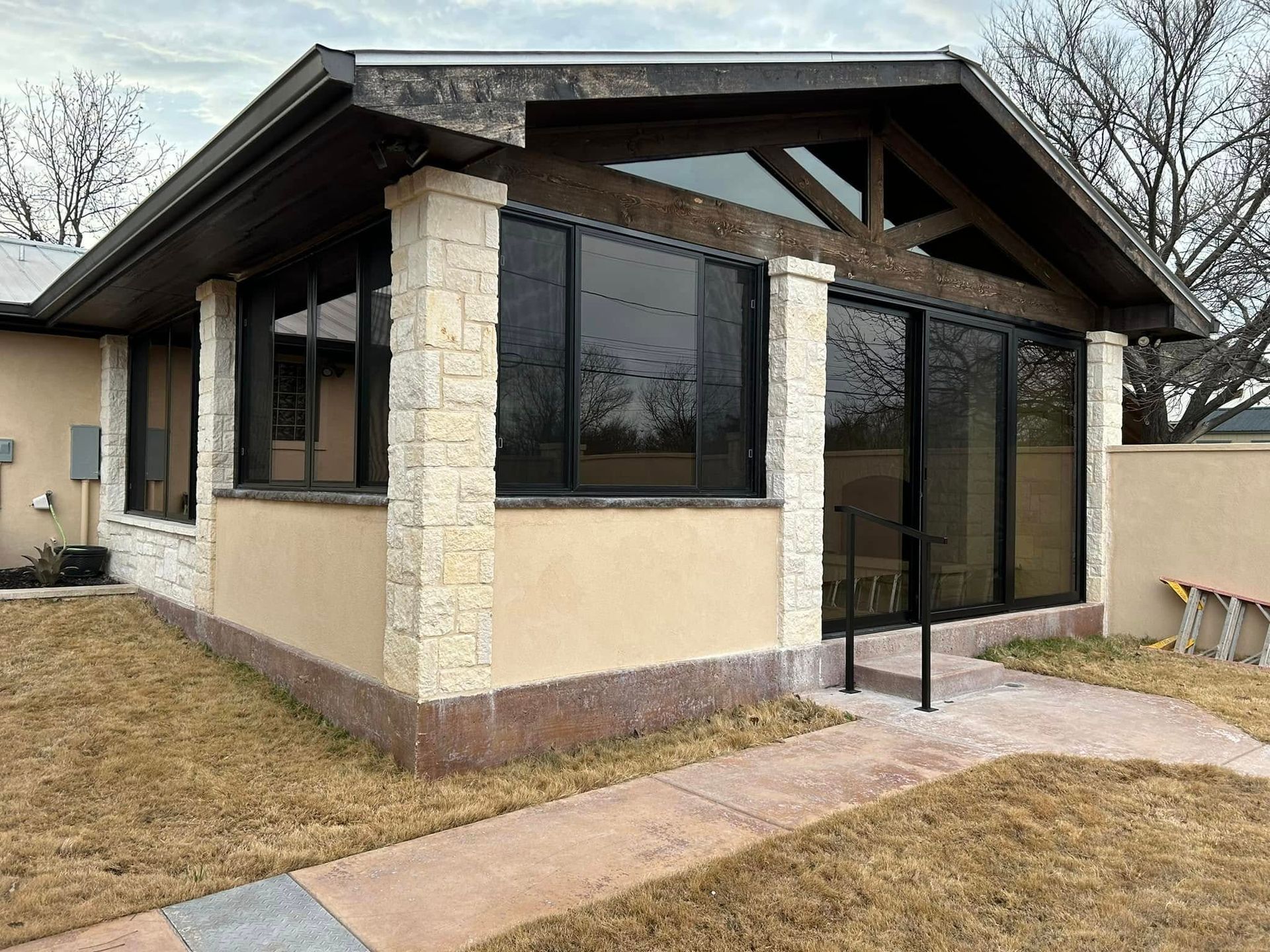 A house with a lot of windows and a walkway leading to it
