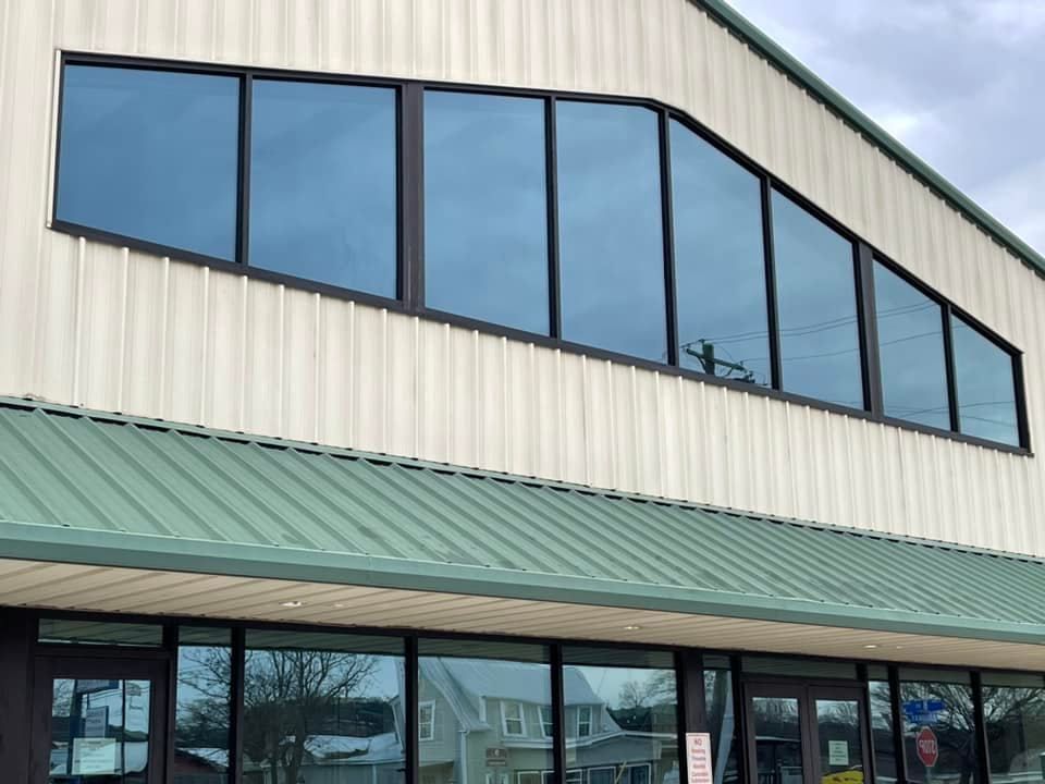 A building with a green roof and a lot of windows