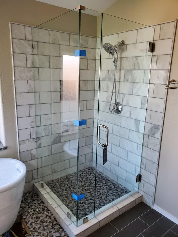 A bathroom with a walk in shower and a bathtub.