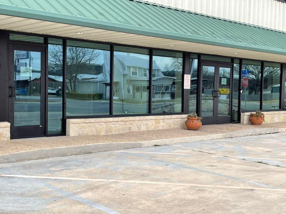 A building with a green roof and a lot of windows