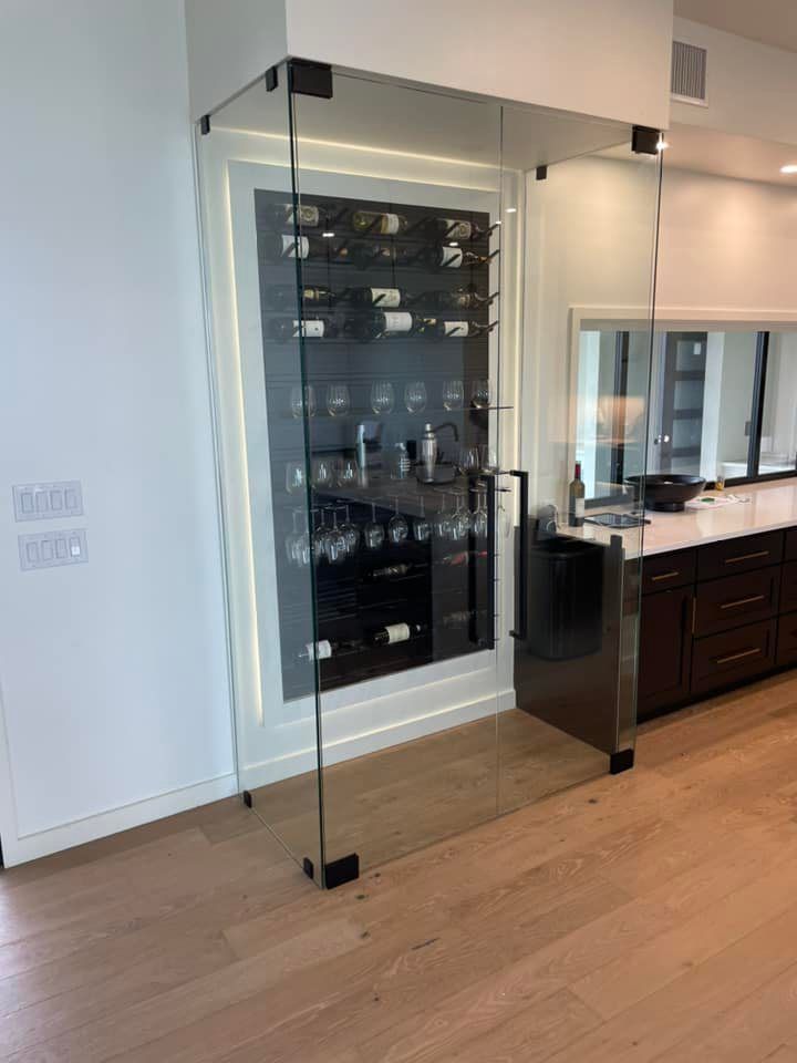 A glass door leading to a wine cellar in a kitchen.