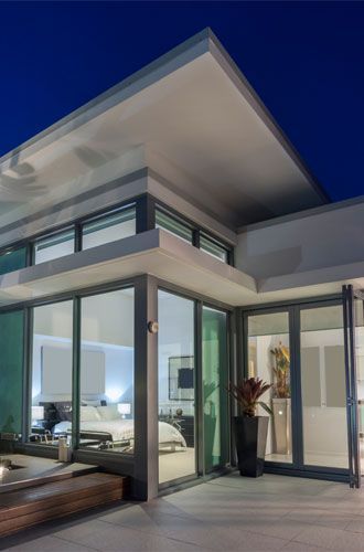 A modern house with a lot of windows and a balcony