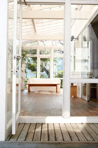 A sliding glass door is open to a kitchen and patio.