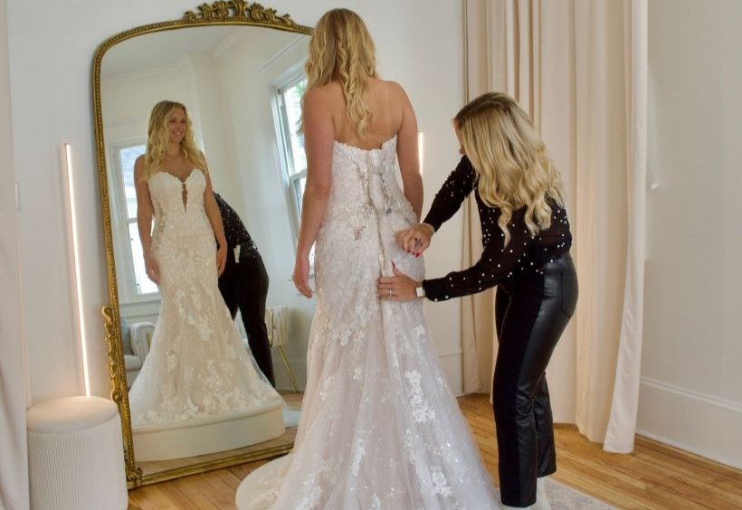 A room filled with lots of wedding dresses and suits.