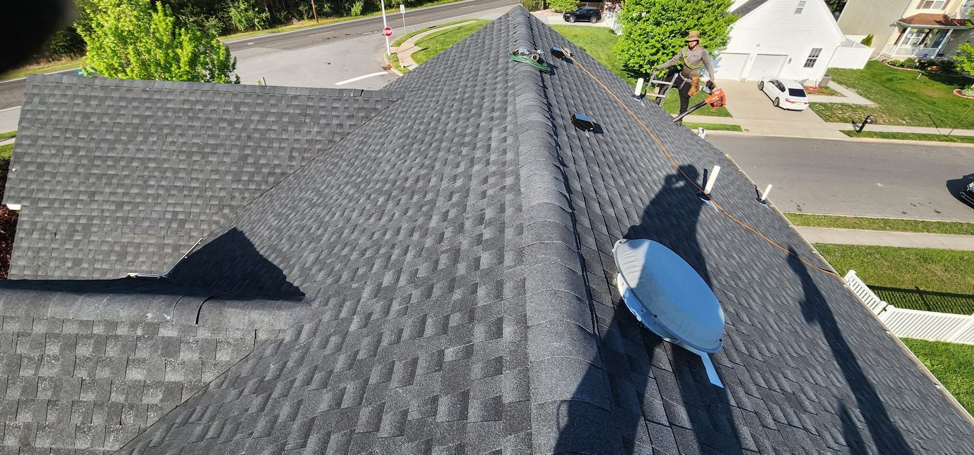 An aerial view of a roof with a satellite dish on it.