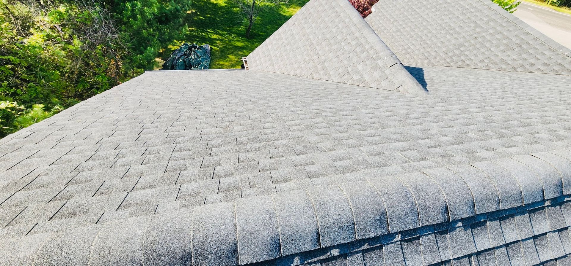 A close up of a roof with a chimney on it.