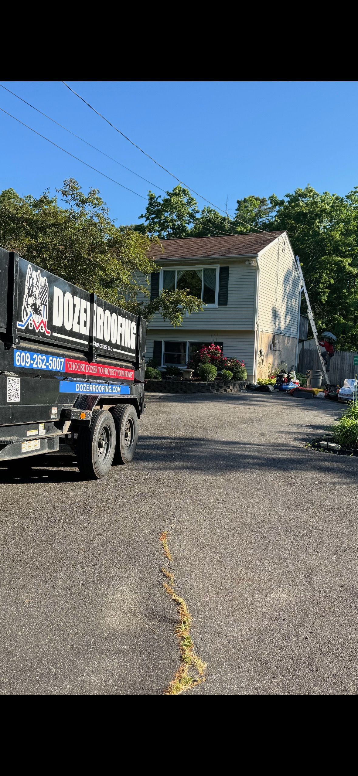 A dump truck is parked in front of a house.
