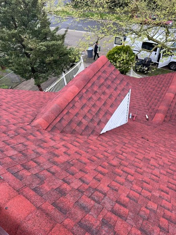 A red roof with a white truck parked on the side of it.