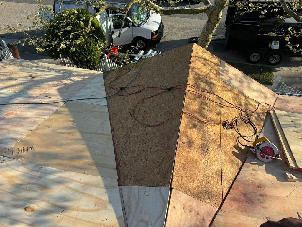 A piece of wood is sitting on top of a wooden roof.