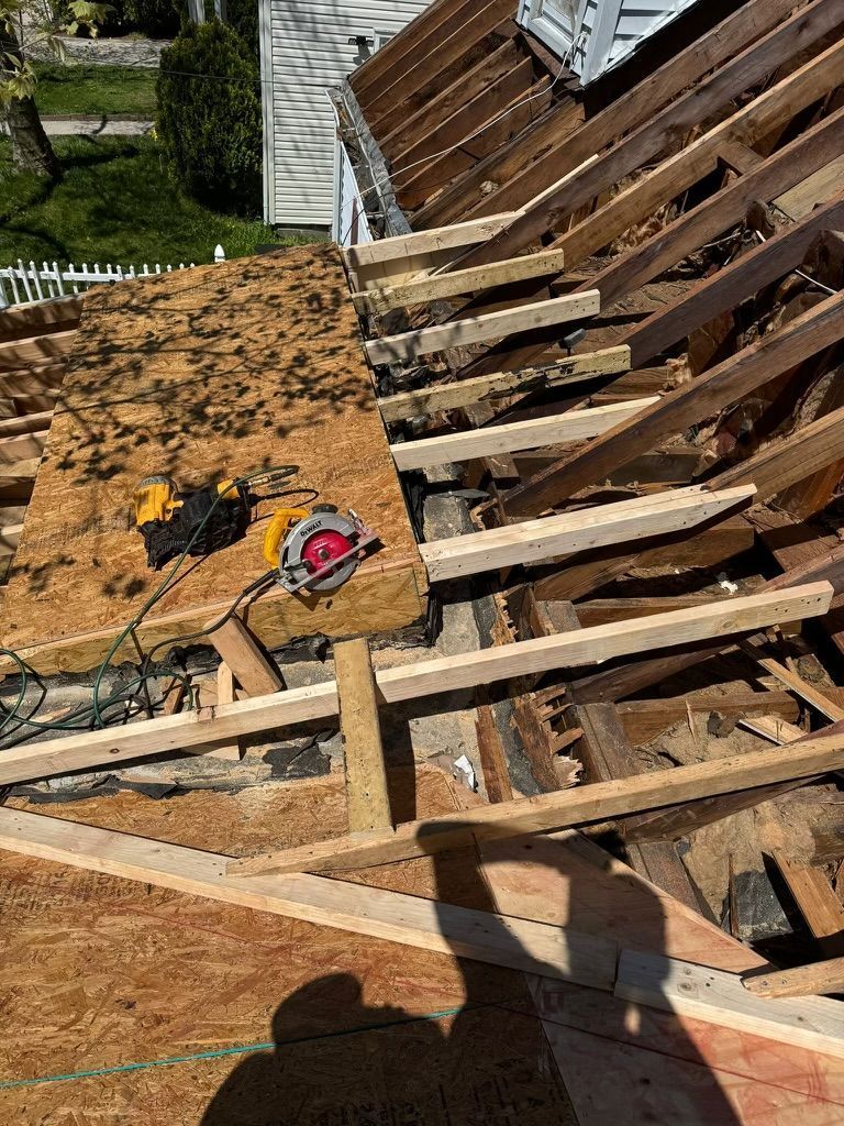 A roof is being removed from a house with a circular saw.