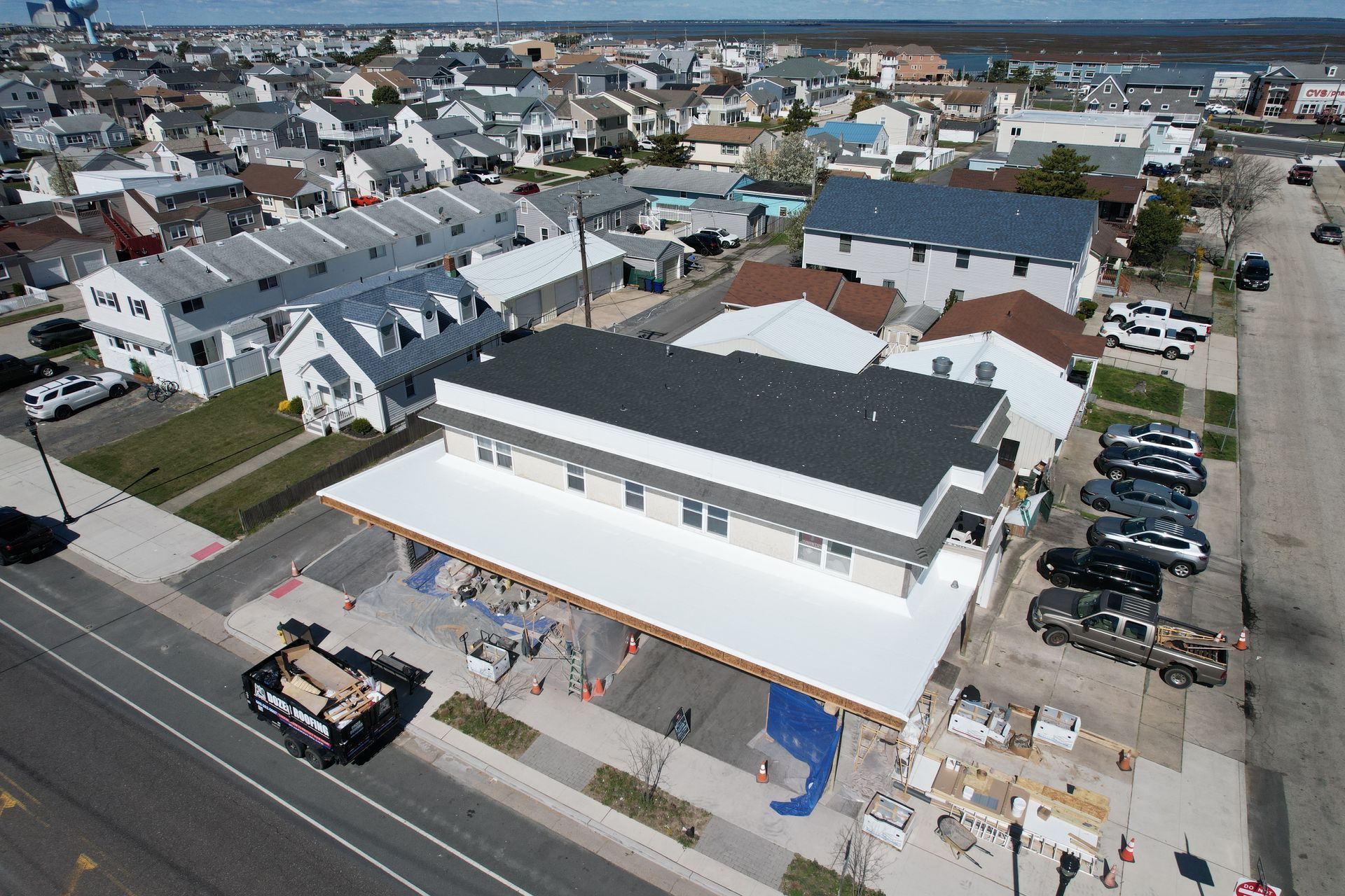 An aerial view of a city with a large white building in the middle