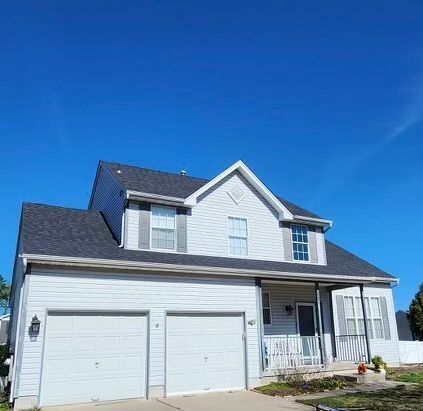 A large white house with a blue sky in the background.