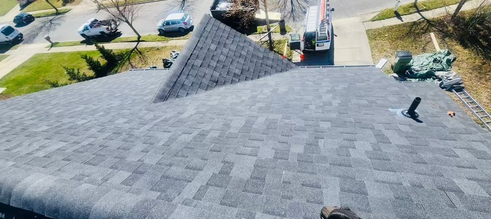 An aerial view of a roof being installed on a house.