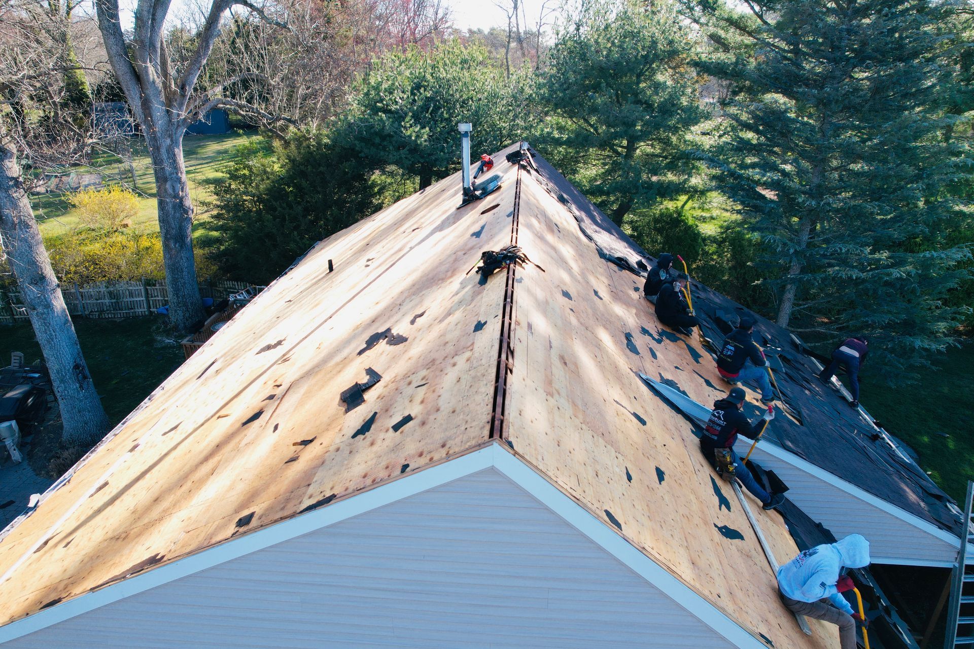 An aerial view of a house with a roof that is being repaired.