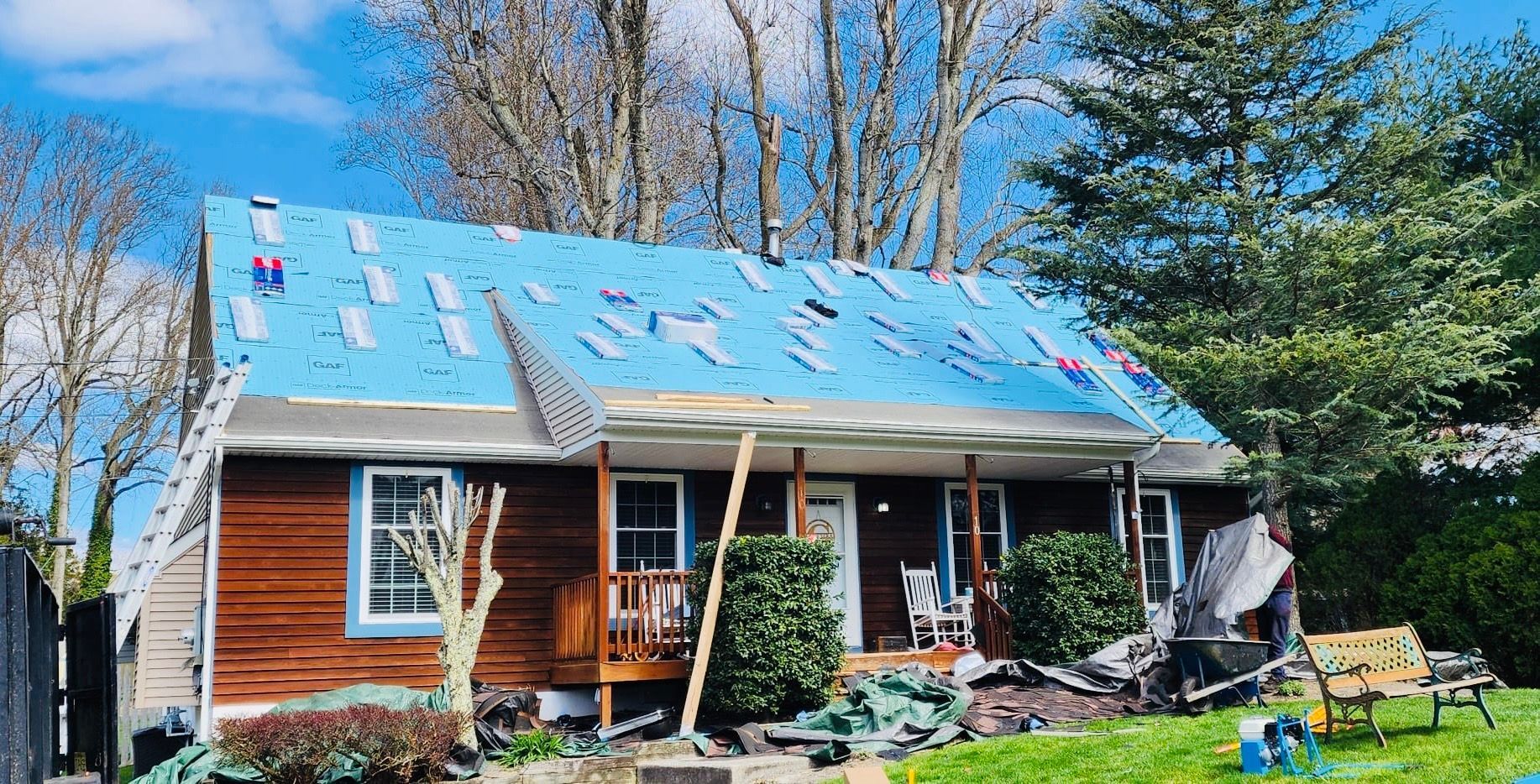 A house with a blue roof is being remodeled.
