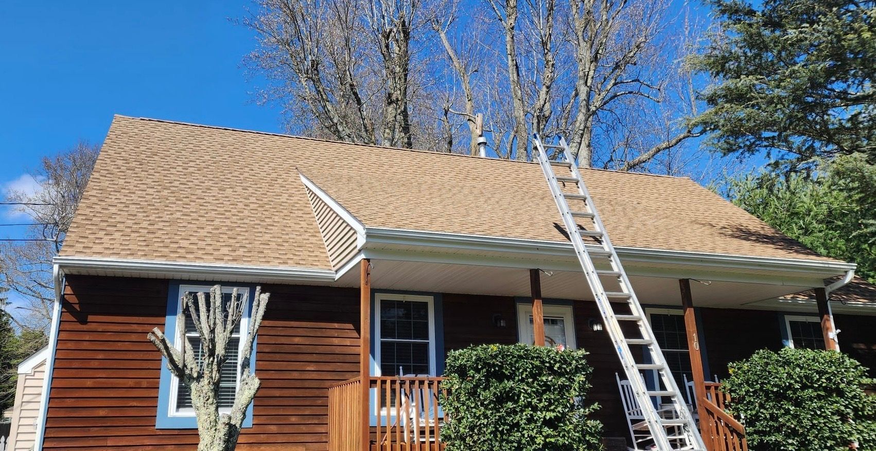A wooden house with a ladder attached to the roof.
