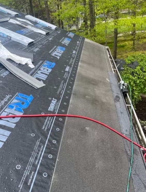 A roof that is being installed with a hose attached to it