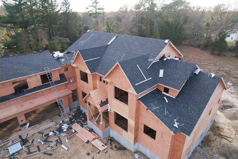 An aerial view of a large house under construction
