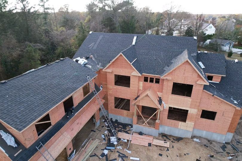 An aerial view of a large house under construction