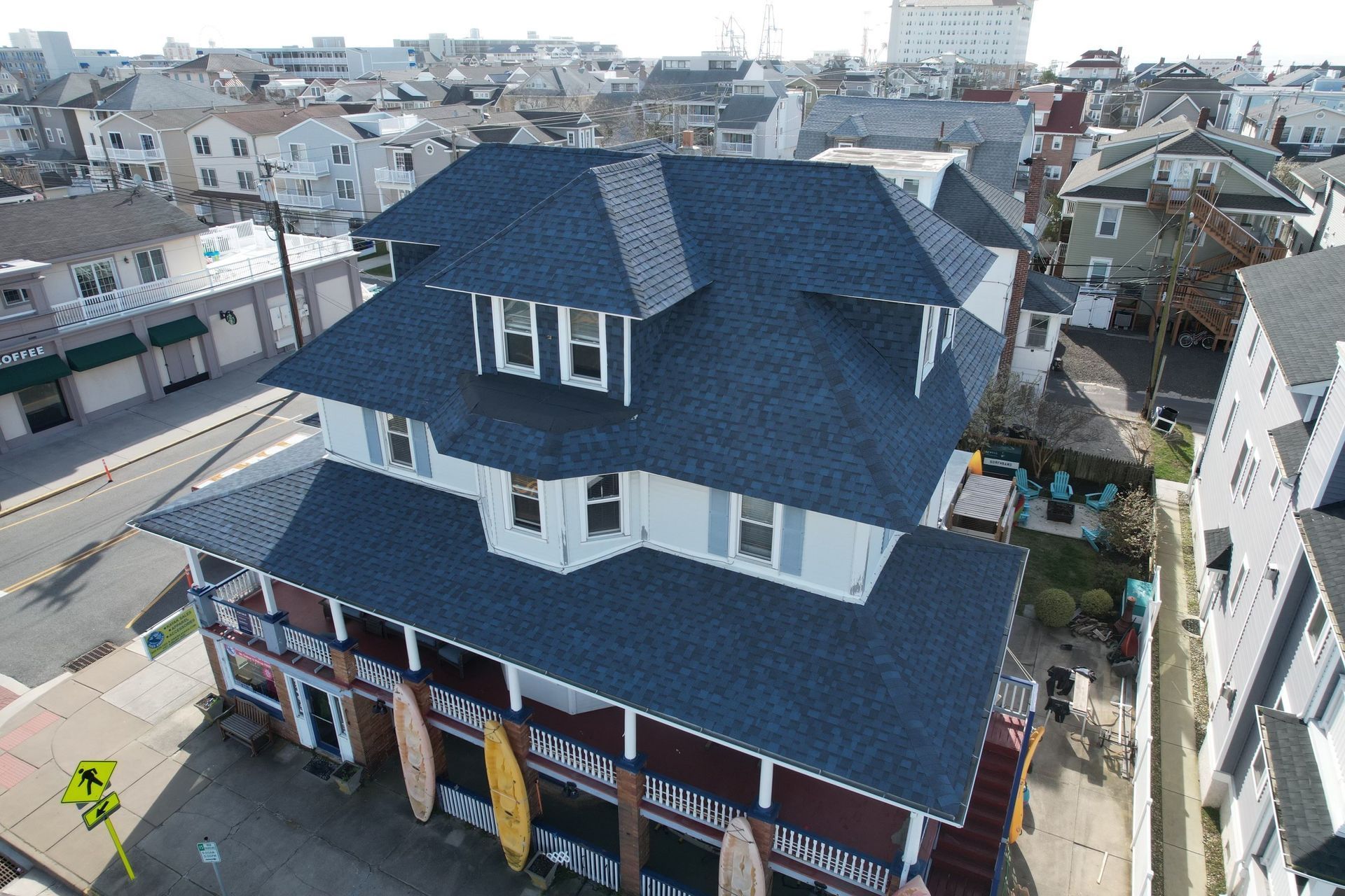 An aerial view of a house with a blue roof