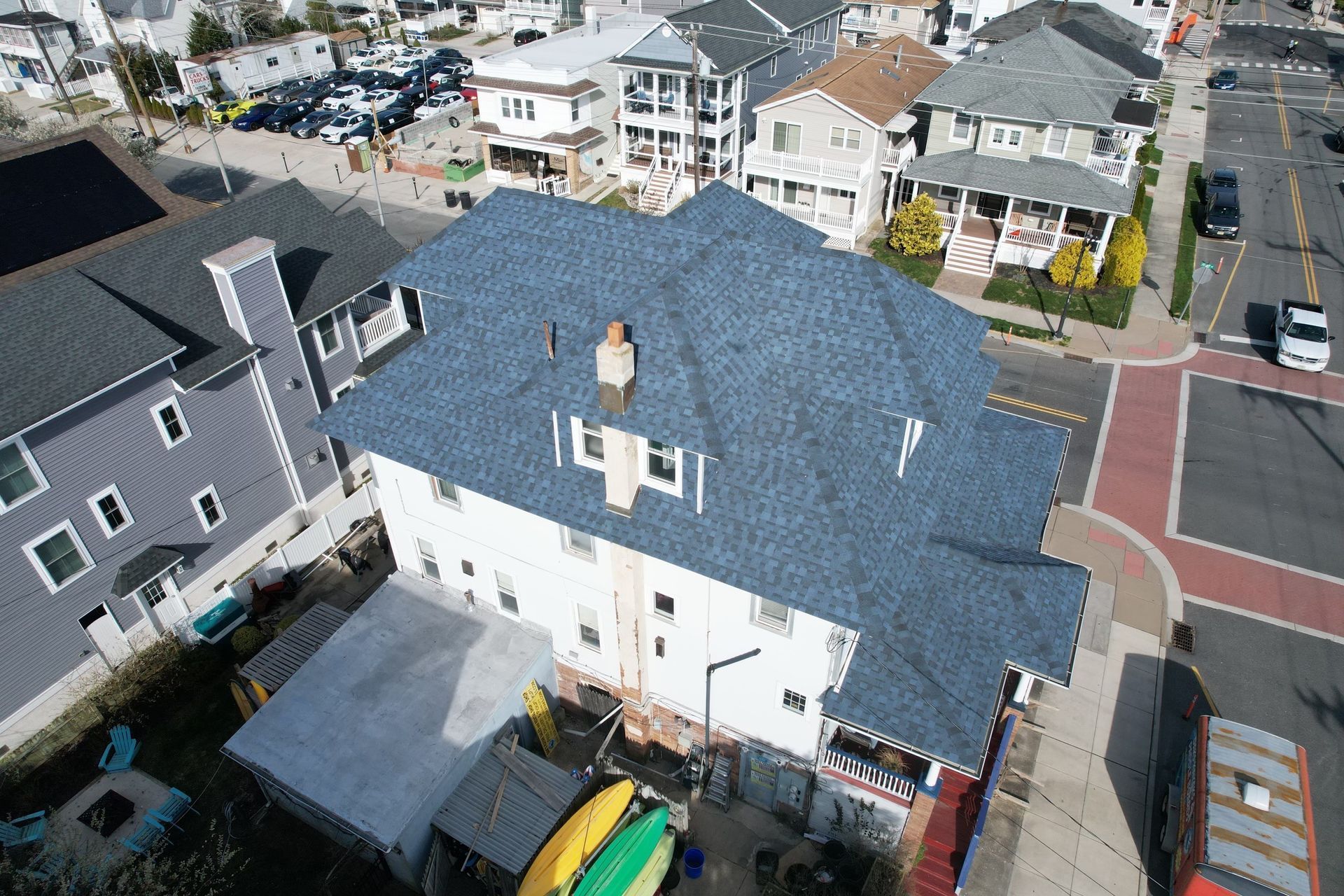 An aerial view of a house with a blue roof
