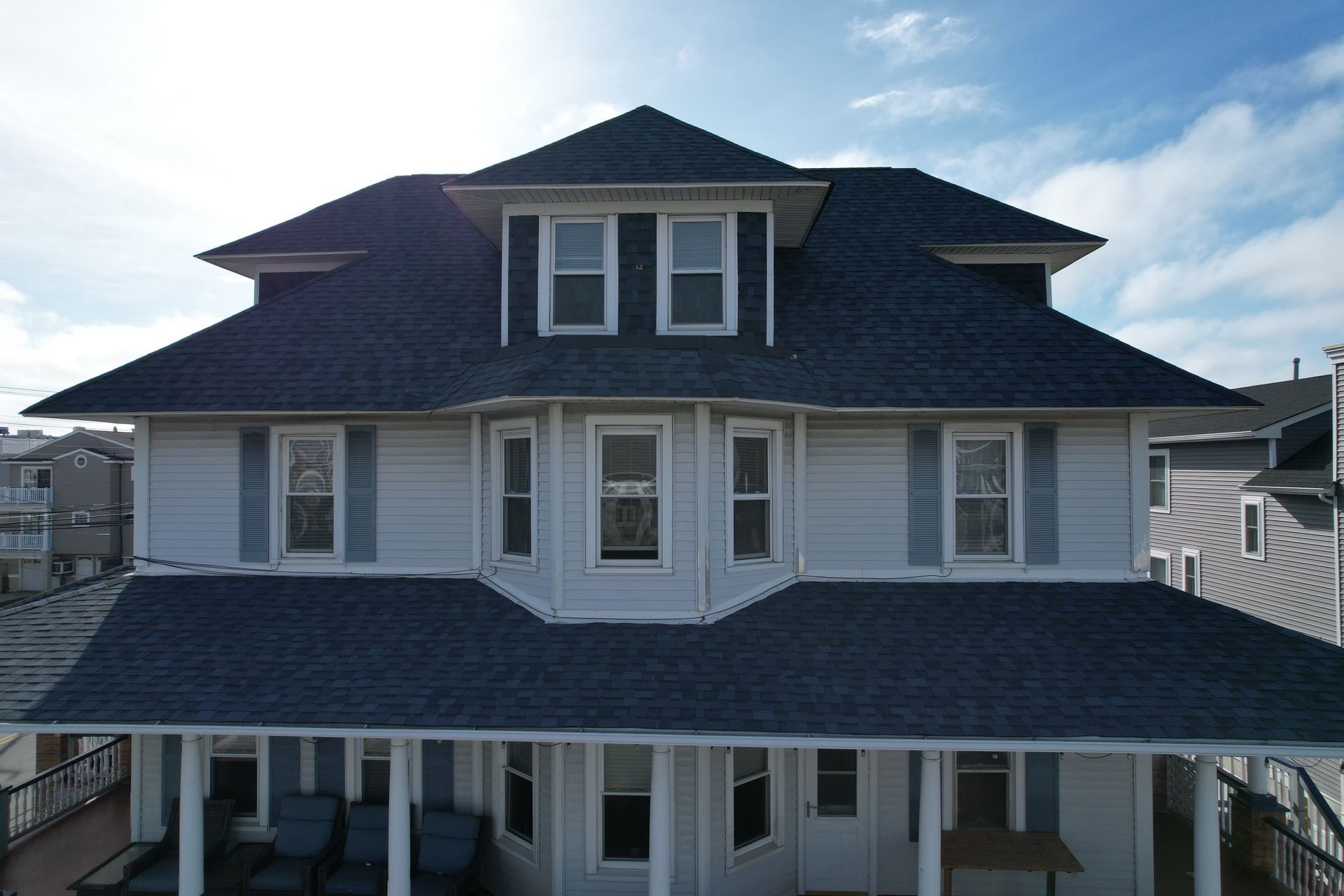 A large white house with a blue roof