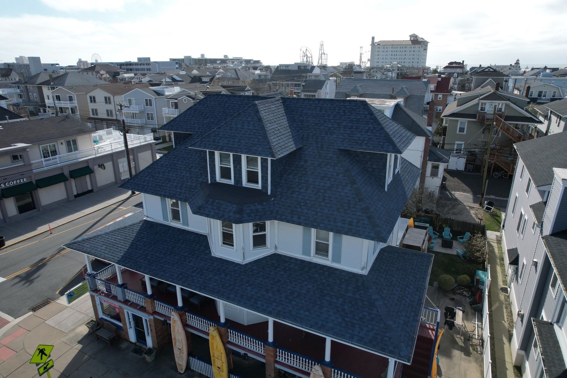 An aerial view of a house with a black roof