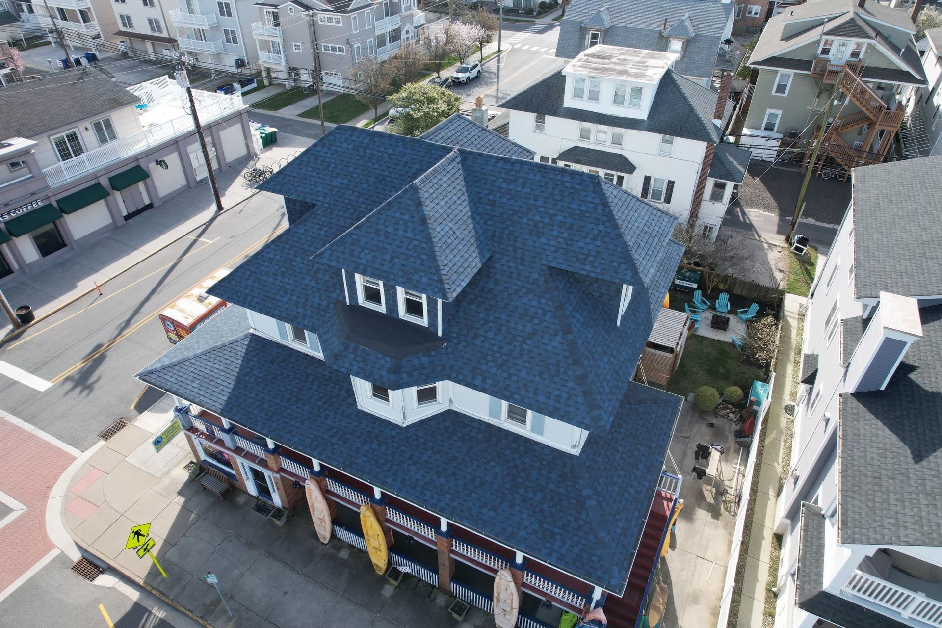An aerial view of a house with a blue roof
