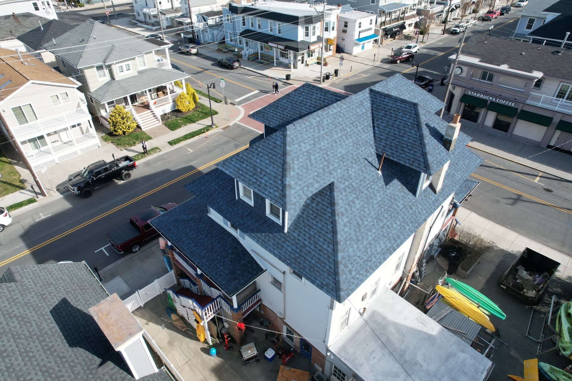 An aerial view of a house with a blue roof