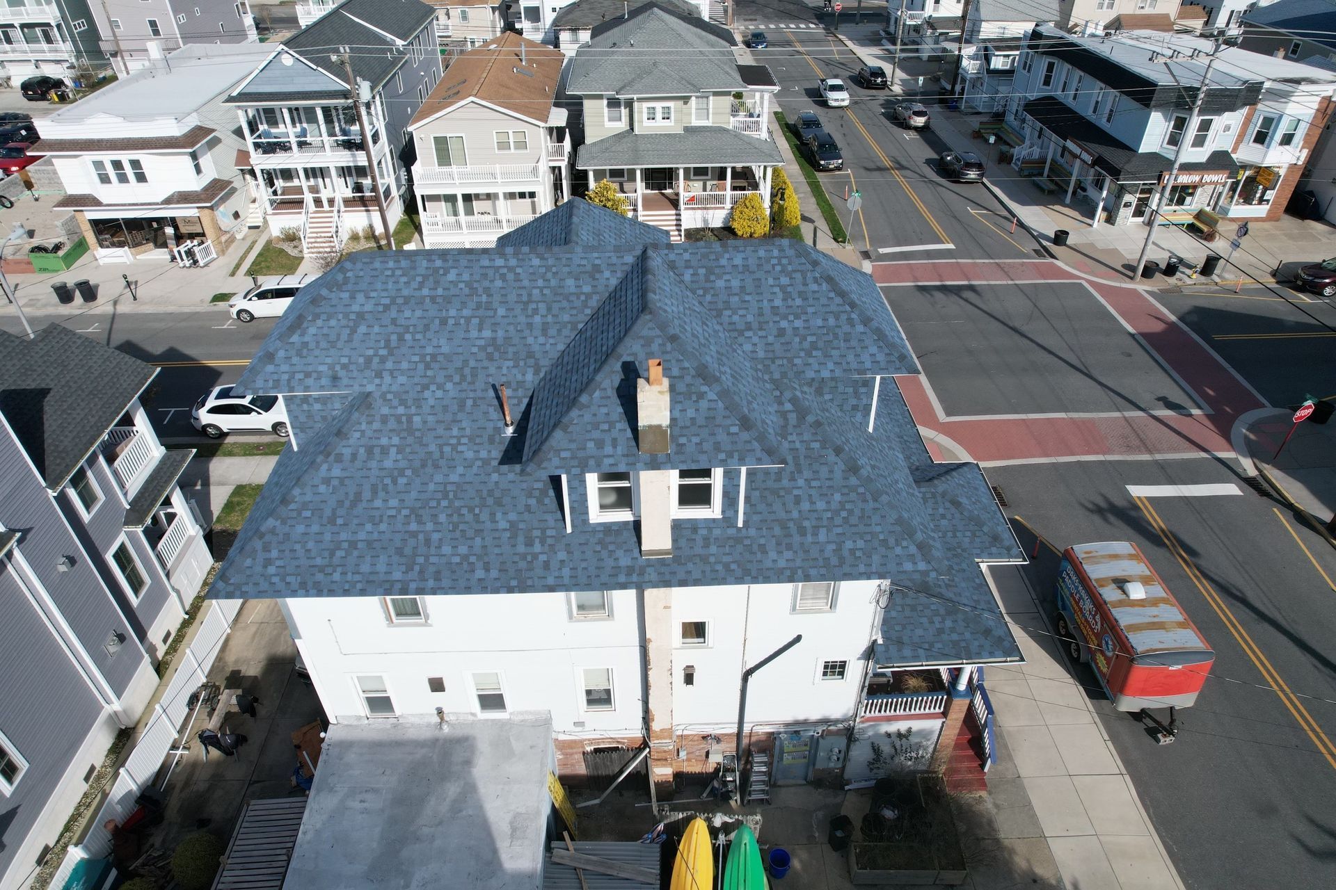 An aerial view of a house with a blue roof