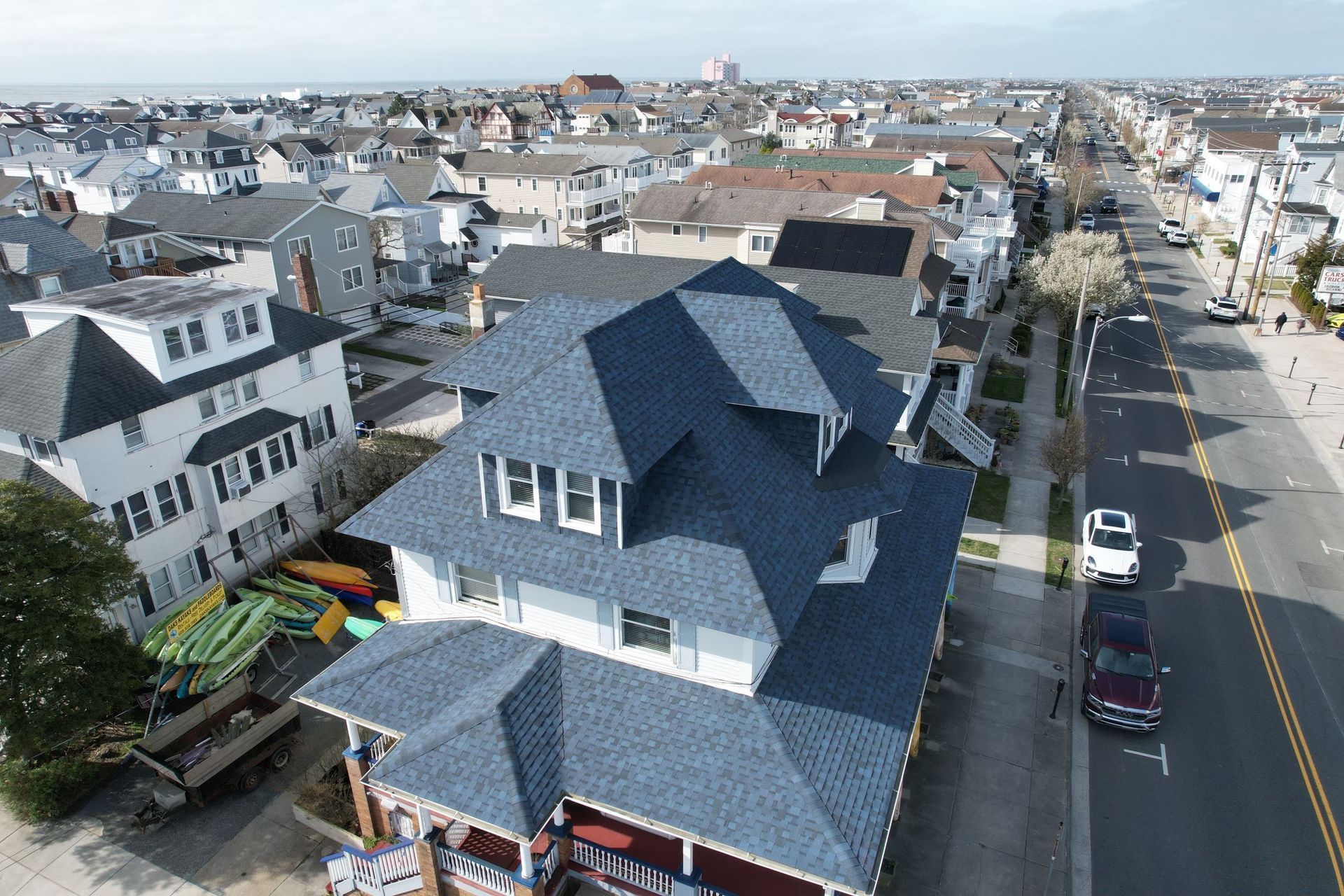 An aerial view of a house with a blue roof