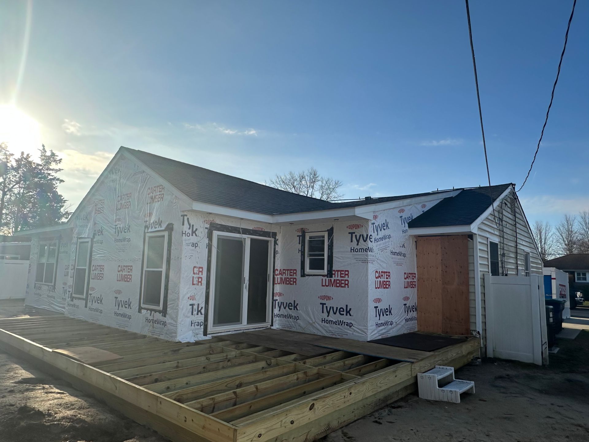 A house is being built with a wooden deck in front of it.